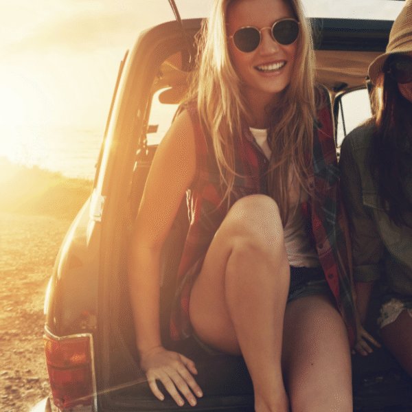two best friends sitting on the open booth of a car