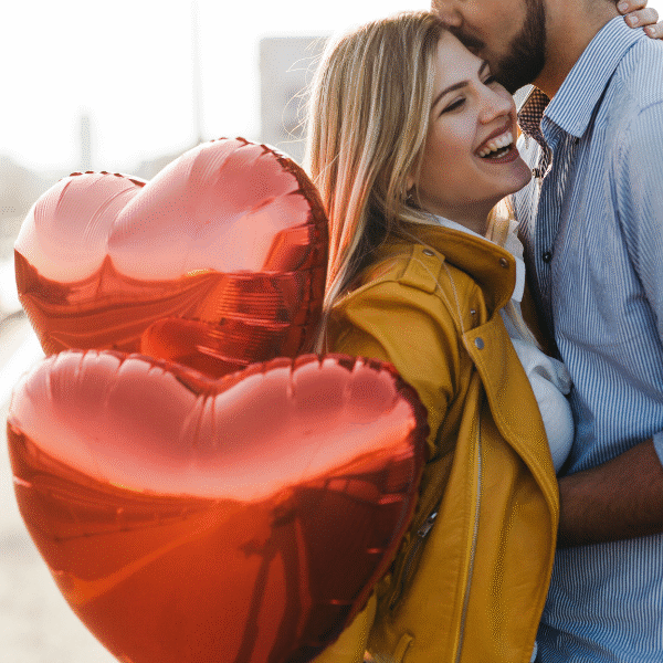 woman-smiling-with-some-heart-shaped-balloons