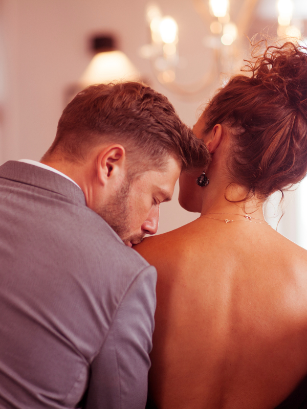man-kissing-a-woman-shoulder