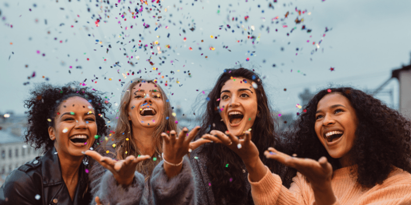 four-ladies-throwing-confetti