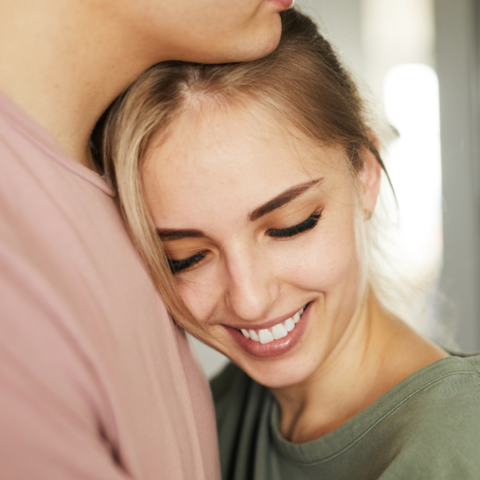 woman-standing-in-mans-arm