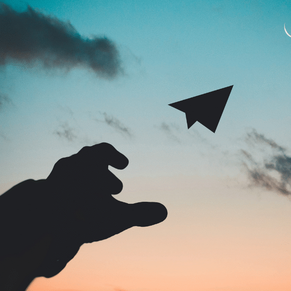 man-hand-sending-a-paper-plane-in-the-sky