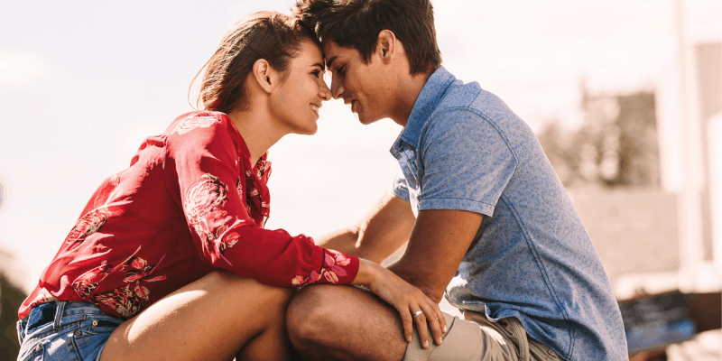 woman looking at her husband with love and affection, touching his forehead