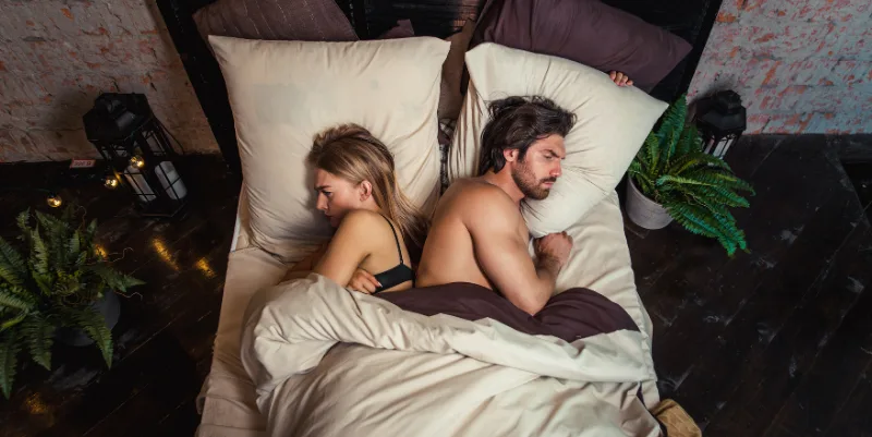 argued-couple-back-in-back-in-bed