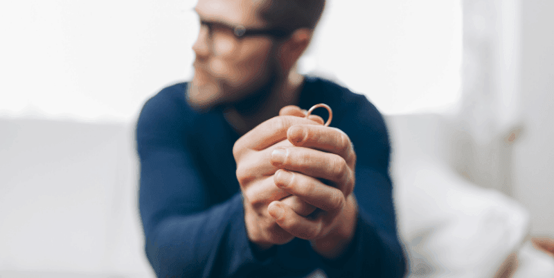 man-holding-wedding-ring