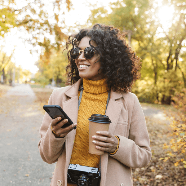 happy-woman-enjoying-her-coffee-in-the-park