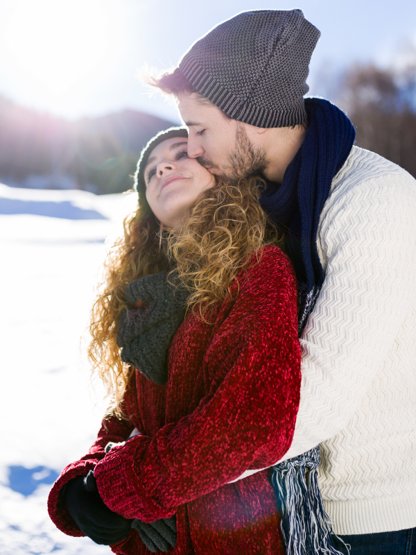 happy couple hugging in the snow
