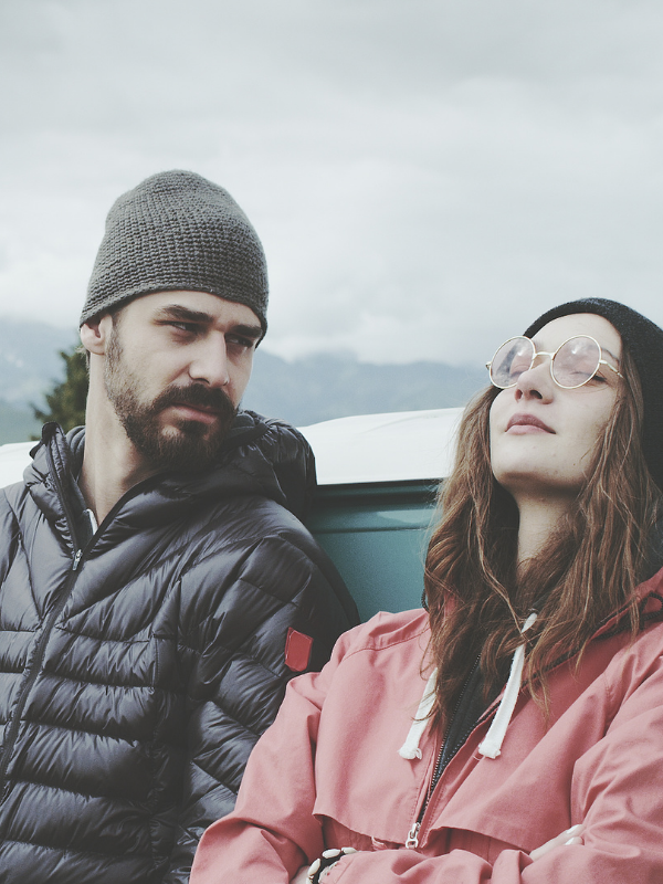 couple leaning on a car
