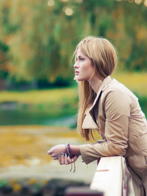 woman staying on a bridge observing the view