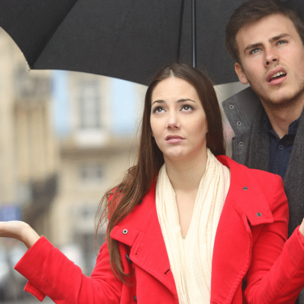 couple looking at a cloudy rainy sky featured photo
