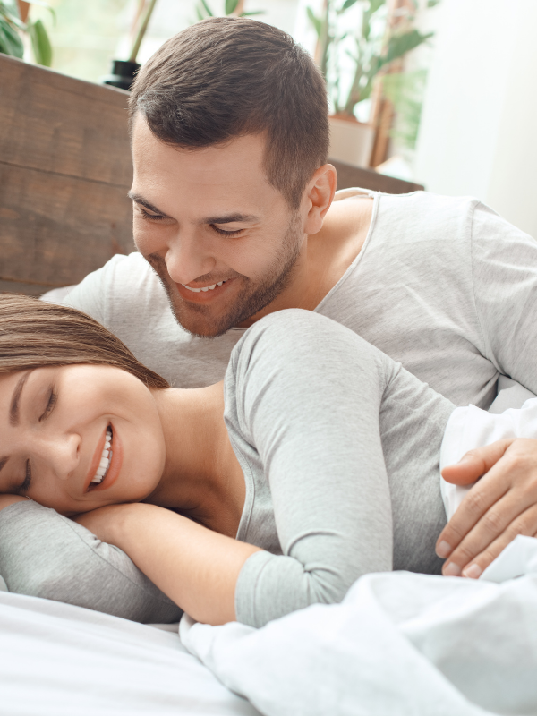 man leaning over a woman both smiling