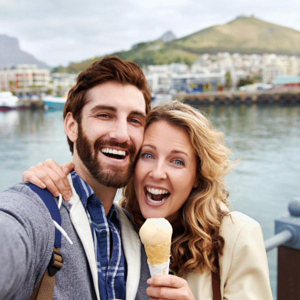 a couple outdoors having fun and taking selfie