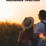 image of a couple standing in the field and enjoying the sunset