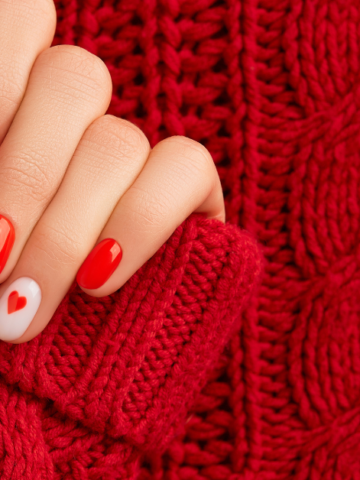 featured photo of a woman's hands with red nails holding the edge of a red knitted sweater